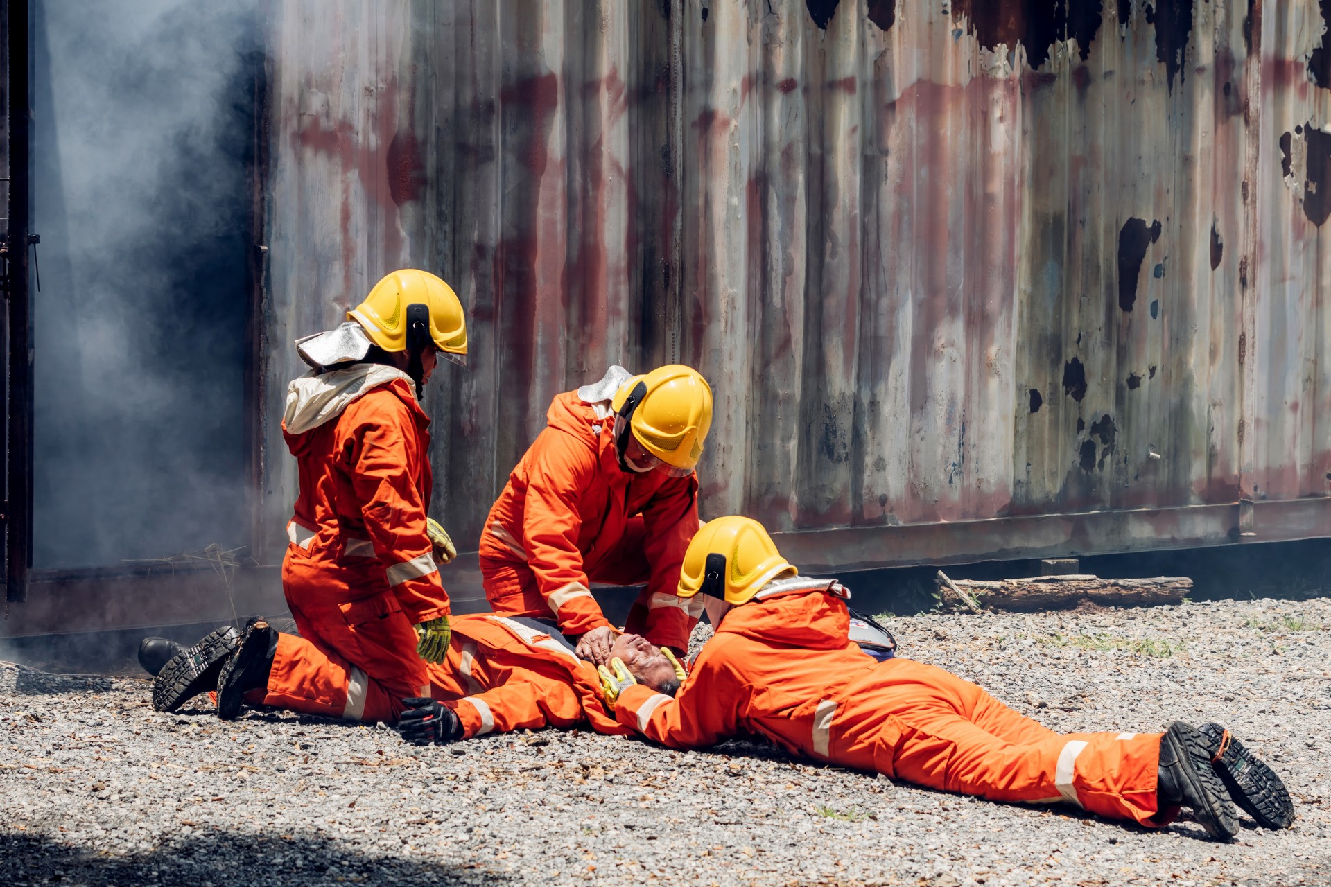 First aid support accident at work. Firefighter to save girl in fire and smoke. Rescue Team or Firefighters save lives people from fire. Firefighter or Emergency team rescue saving life people