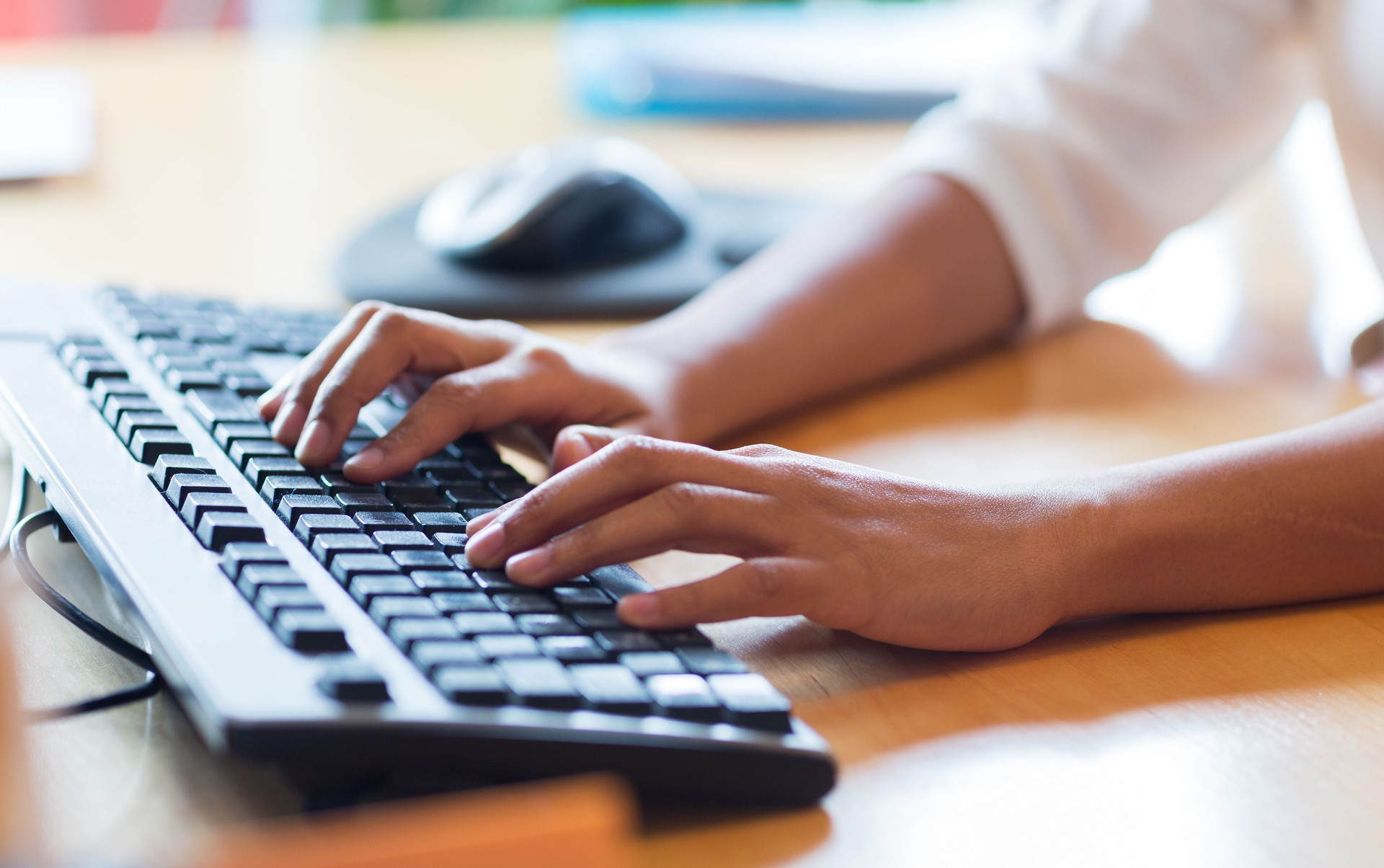 close up of female hands typing on keyboard