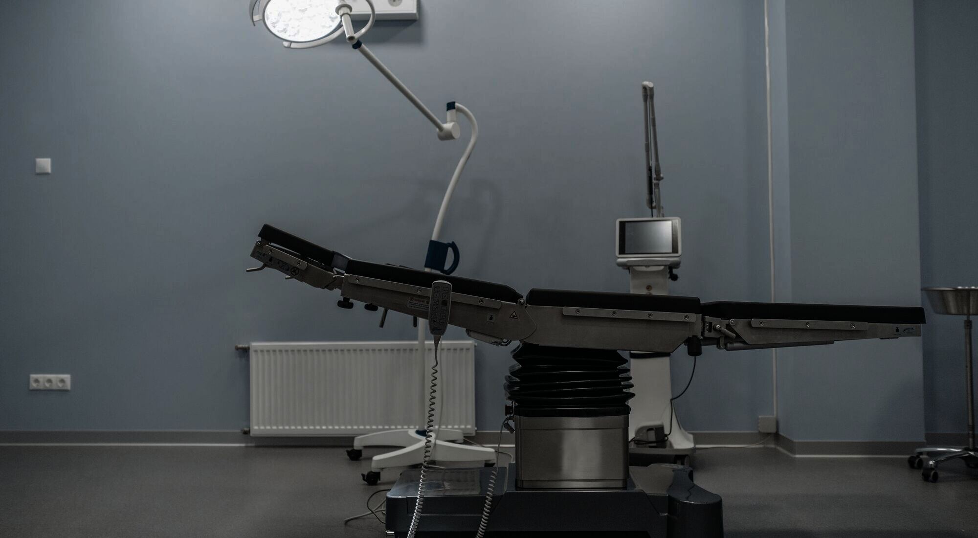 An empty operating theatre, the operating table and surgical light unattended